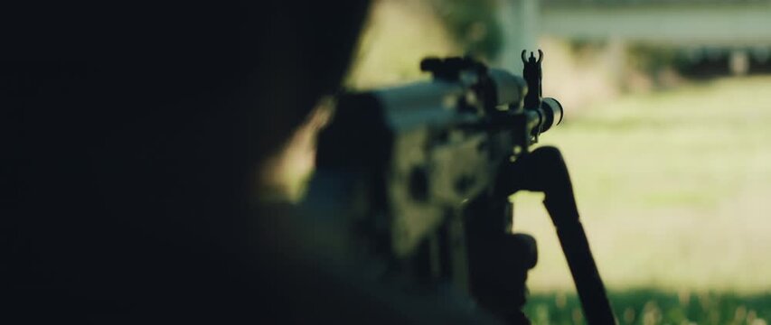 Shooter aiming through rifle sight with target downrange in background