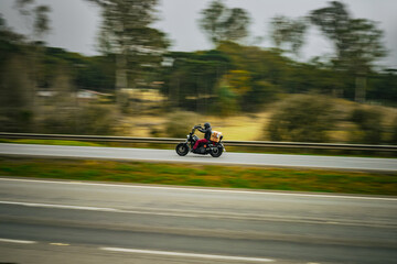 Obraz premium Freedom in Motion: Motorcycle Rider on Open Highway