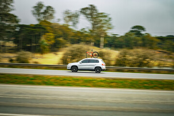 Adventure in Motion: Silver SUV with Rooftop Bike