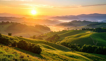 Golden sunrise over rolling green hills with scattered trees and distant misty mountains creating peaceful and warm natural landscape full of calm and beauty