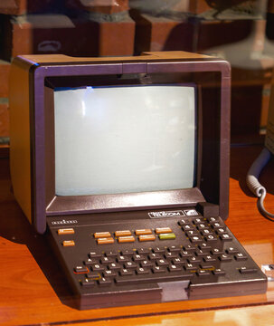 Paris, France - Apr 20, 2025: Vintage French Minitel terminal with a bulky CRT screen and integrated keyboard sits on a wooden surface, showcasing the classic design of early digital communication