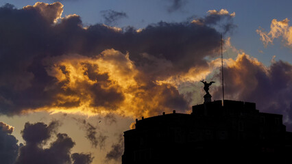 Beautiful sunset sky and clouds over Rome with Holy Angel statue silhouette