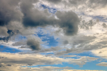 Dramatic cloudscape filling the sky with varying shades of grey and blue