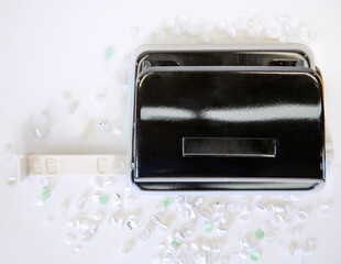 Black hole punch creating confetti from paper on white background