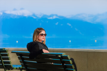 Woman sitting on a bench and staring into the distance
