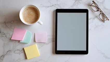 Tablet, coffee, notes, glasses on marble desk; workspace