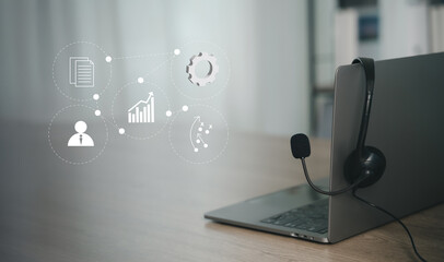 Laptop with headset and digital business icons overlay, representing online entrepreneur concept, remote communication, strategy planning, and growth in the modern digital economy.