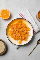 Healthy dessert with sliced pumpkin, honey and orange juice in a bowl. Healthy pumpkin dish.