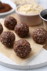 Making homemade candies. Chocolate balls and ingredients on table, closeup