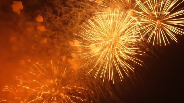 Explosive gold fireworks bloom in a dark sky, sparkling and glowing