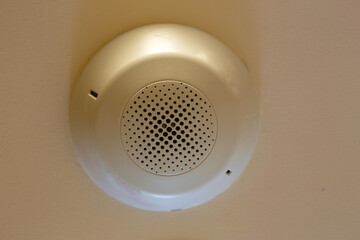 Ceiling-mounted smoke detector device.