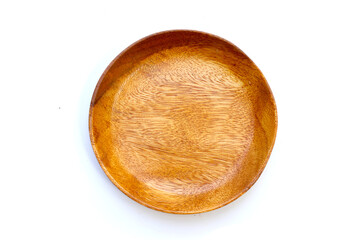 Top view of wooden plate on white background