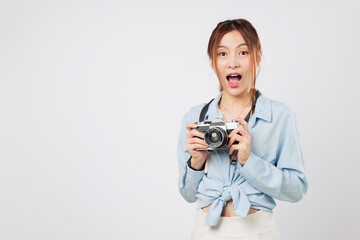 Tourist snapshot moment, woman with camera like a true tourist. Happy young traveler holds her...