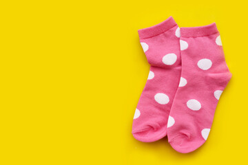 Pink socks with white polka dot pattern