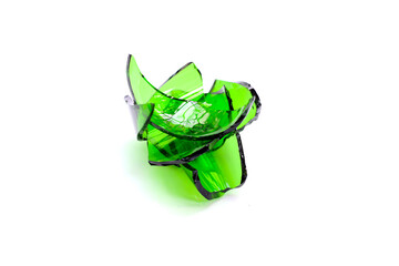 Sharp green glass shards scattered on a white background.