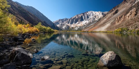 Obraz premium Picturesque Autumnal Lake Reflection with Majestic Mountains and Crystal Clear Water, Ideal for Travel and Outdoor Scenery