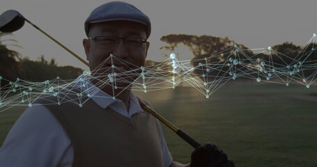 Standing Chinese golfer wearing cap and vest, holding club on fairway with digital network overlay