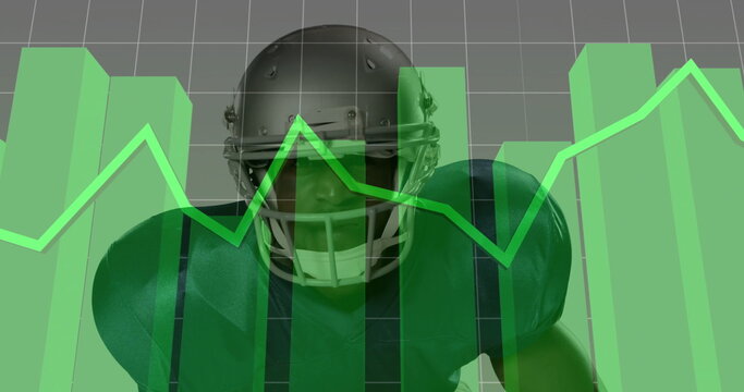 Crouching football player in green jersey and silver helmet in analytics backdrop with green charts
