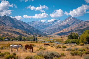 Majestic Mountain Landscape with Horses Grazing in a Scenic Valley Under a Bright Blue Sky with Fluffy White Clouds, Capturing the Beauty of Nature in Every Detail