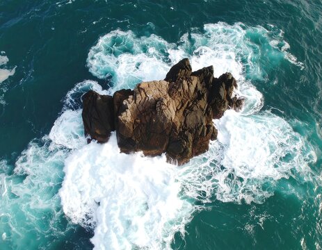 Rocky islet amidst the ocean waves
