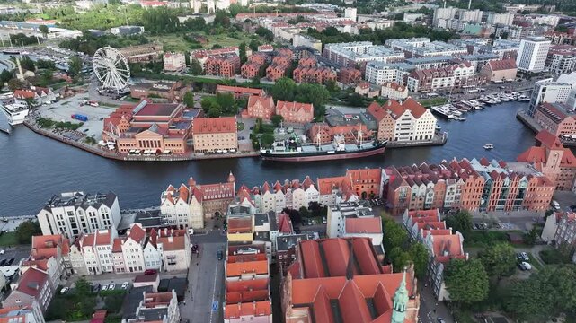 Aerial Gdansk Poland old town Motlawa River slide 4K. Baltic coast of northern Poland. World War II started here with German invasion. Economic international port. Historical buildings, tourism.