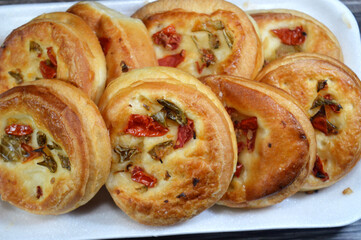A plate with a pile of Vegetables vegetarian toppings Pizzette Pizzetta mini Pizza, a small pizza topped with pieces of tomatoes and peppers, baked in the oven and served as a snack
