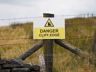 Warning sign on a rural fence