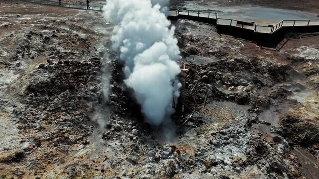 Close-up aerial of steaming vent in Gunnuhver geothermal area Reykjanes. Filmed in 4K revealing colorful mineral ground and geothermal energy release.