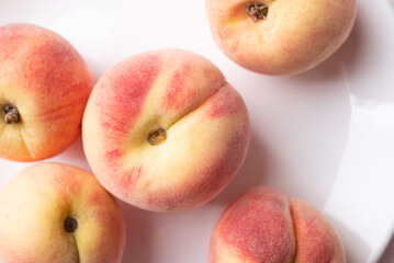 Pink peaches on white plate, Summer fruit, Top view