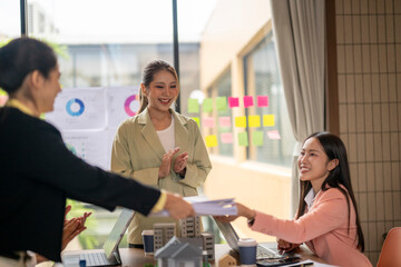 Fototapeta premium Businesswomen congratulating colleague on successful project completion