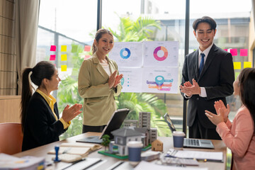 Real estate agents clapping after successful business meeting in office