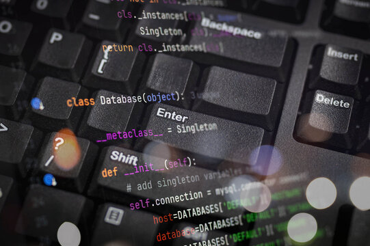 Close-up of computer keyboard with Python code overlay, illustrating software development, database programming, coding concepts, and tech innovation in modern IT environments.