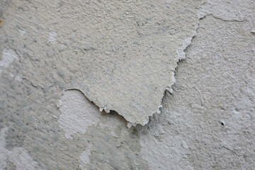 Old wall with peeling paint, cracks, and weathered surface. Useful as a background, texture, or concept image for themes such as decay, aging, renovation, construction, damage, and imperfection
