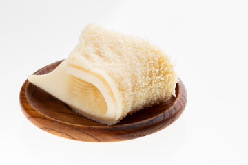 A raw honeycomb tripe in chunks on a wooden plate - second beef stomach