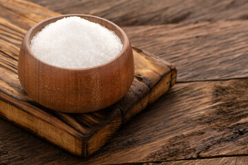 Refined white sugar in a wooden bowl - Fine crystals