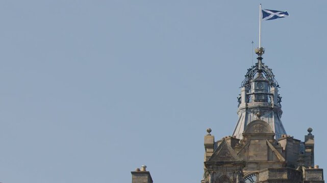 Scottish Flag Waving Atop Historic Edinburgh Castle Tower