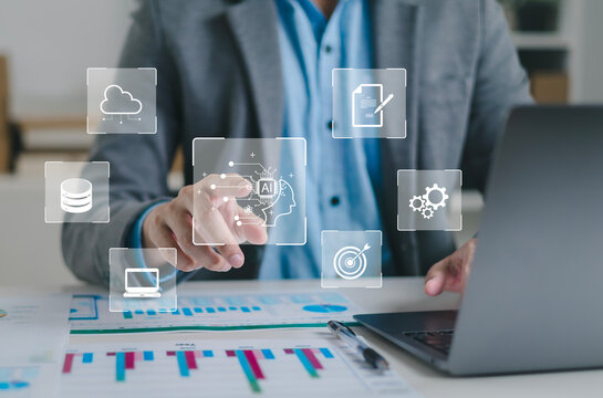 Businessman using laptop to control AI at desk in office. Artificial intelligence is analyzing data and generating reports. Artificial intelligence and intelligent automation (IA) technology.