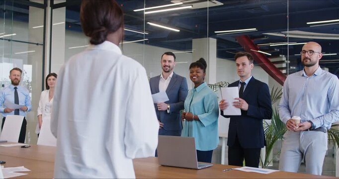 Successful multicultural group of business people standing in a conference room. Concept for holding a corporate event, negotiations, merger of companies. Shareholders meeting, training