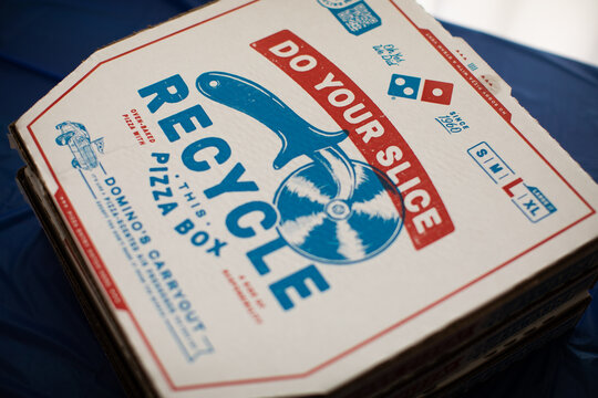 A closed hot box of Dominos Pizza on the table