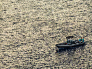 Naklejka premium Rigid Hull Inflatable Boat On Late Sea