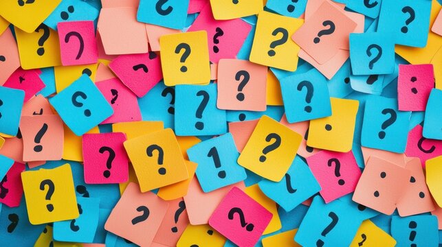A colorful array of sticky notes with question marks on them, scattered across a background of various colors.