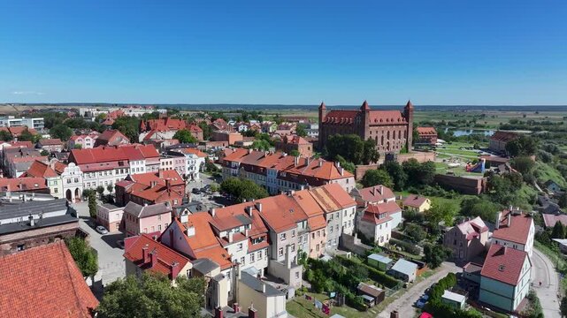 Aerial Gniew Poland historic brick castle and church 2. Northern Poland. Castle construction 13th century by Teutonic Knights. Vistula River. Agriculture land, river, forest and farm rural area.