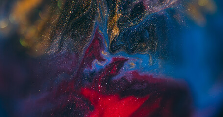 Pour paint. Blur glitter texture. Defocused blue red yellow colorful liquid sparkling water on abstract dark black bokeh art background.