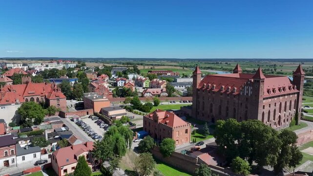 Aerial Gniew Poland historic brick castle and church 3. Northern Poland. Castle construction 13th century by Teutonic Knights. Vistula River. Agriculture land, river, forest and farm rural area.