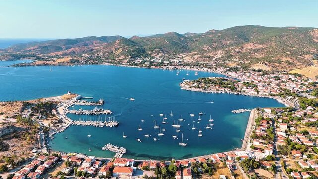 Foca 4k drone video with its windmills, marina and beaches in Izmir, Turkiye.