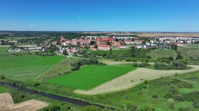 Aerial Gniew Poland historic brick castle and village 1. Northern Poland. Castle construction 13th century by Teutonic Knights. Vistula River. Agriculture land, river, forest and farm rural area.