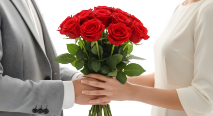 Man giving a bouquet of red roses to a woman in a white dress