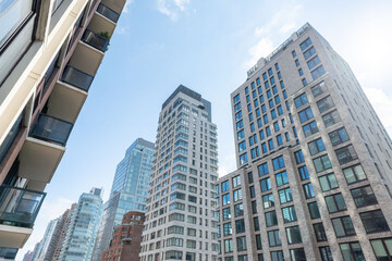 Fototapeta premium High-rise buildings in Midtown Manhattan with modern glass facades, city streets, and urban skyline views in New York City. 