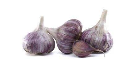 Fresh purple garlic bulbs and a clove are presented on a bright white backdrop.