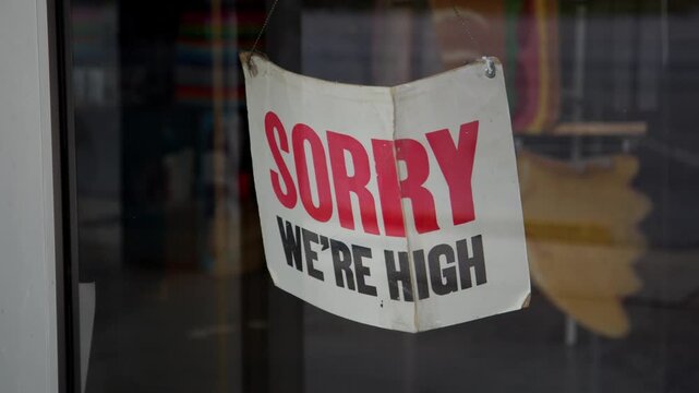 Funny Storefront Sign Reading &ldquo;Sorry We&rsquo;re High&rdquo; instead of Closed